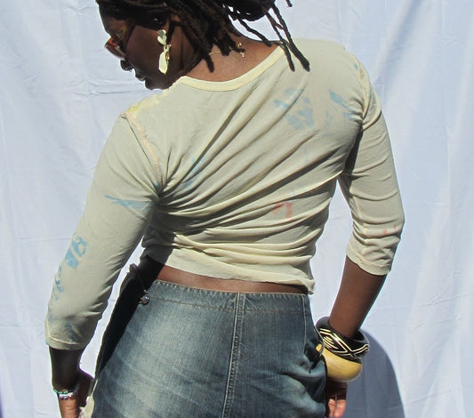 Person standing in front of a white sheet outdoors with a dark background
