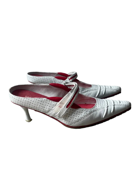 White high-heeled shoes with red interior lining on a white background
