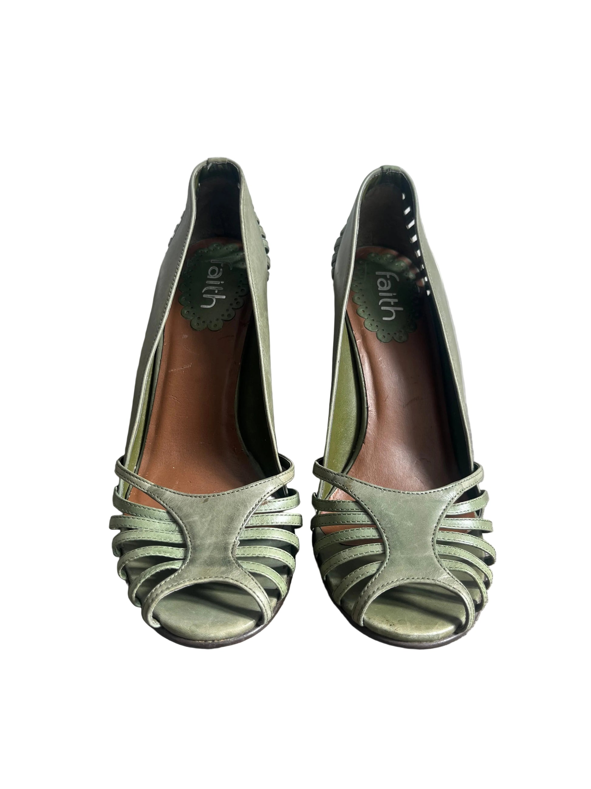 Pair of green high-heeled shoes on a white background.