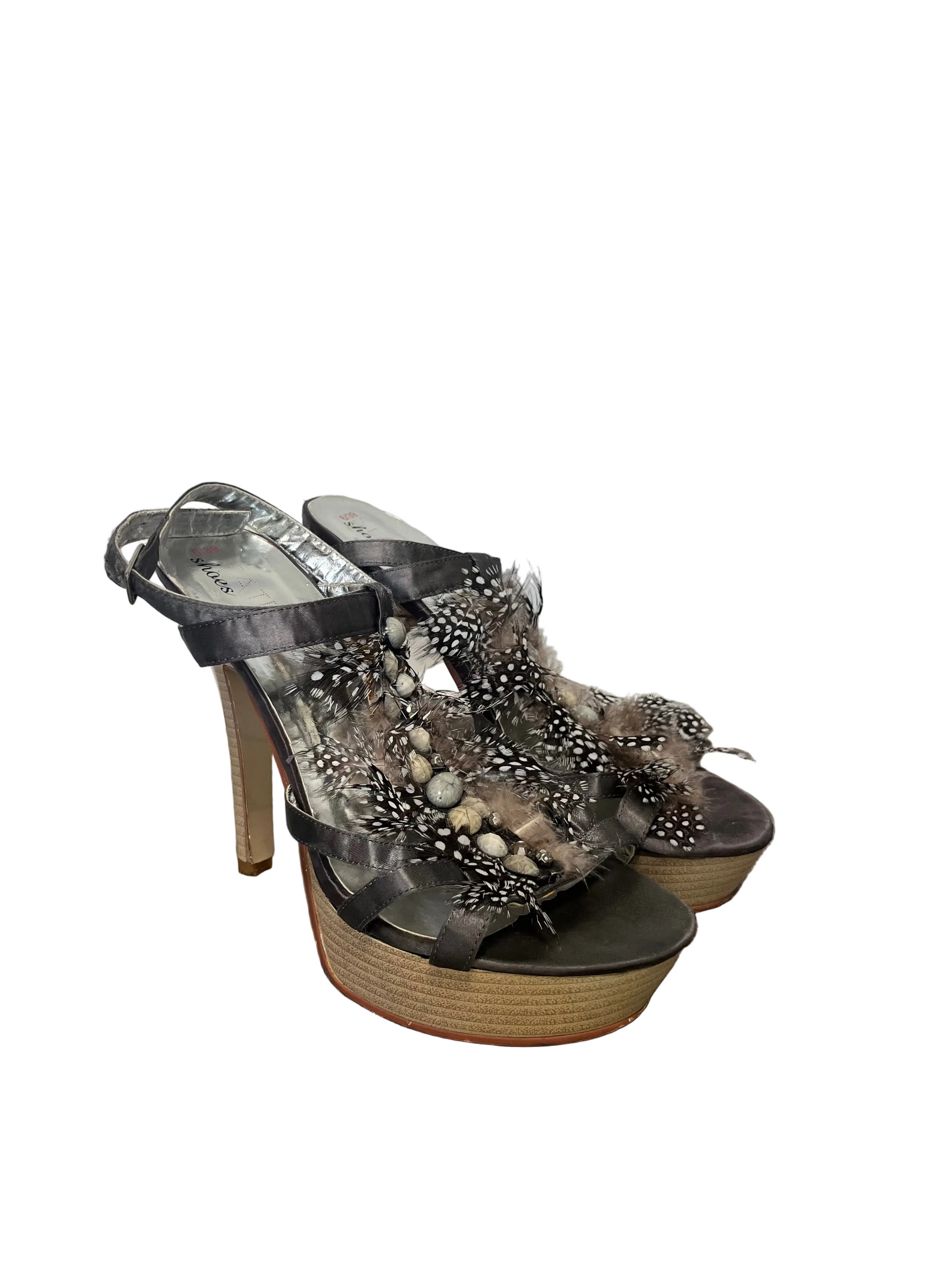 Decorative high-heeled shoes with embellishments on a white background.