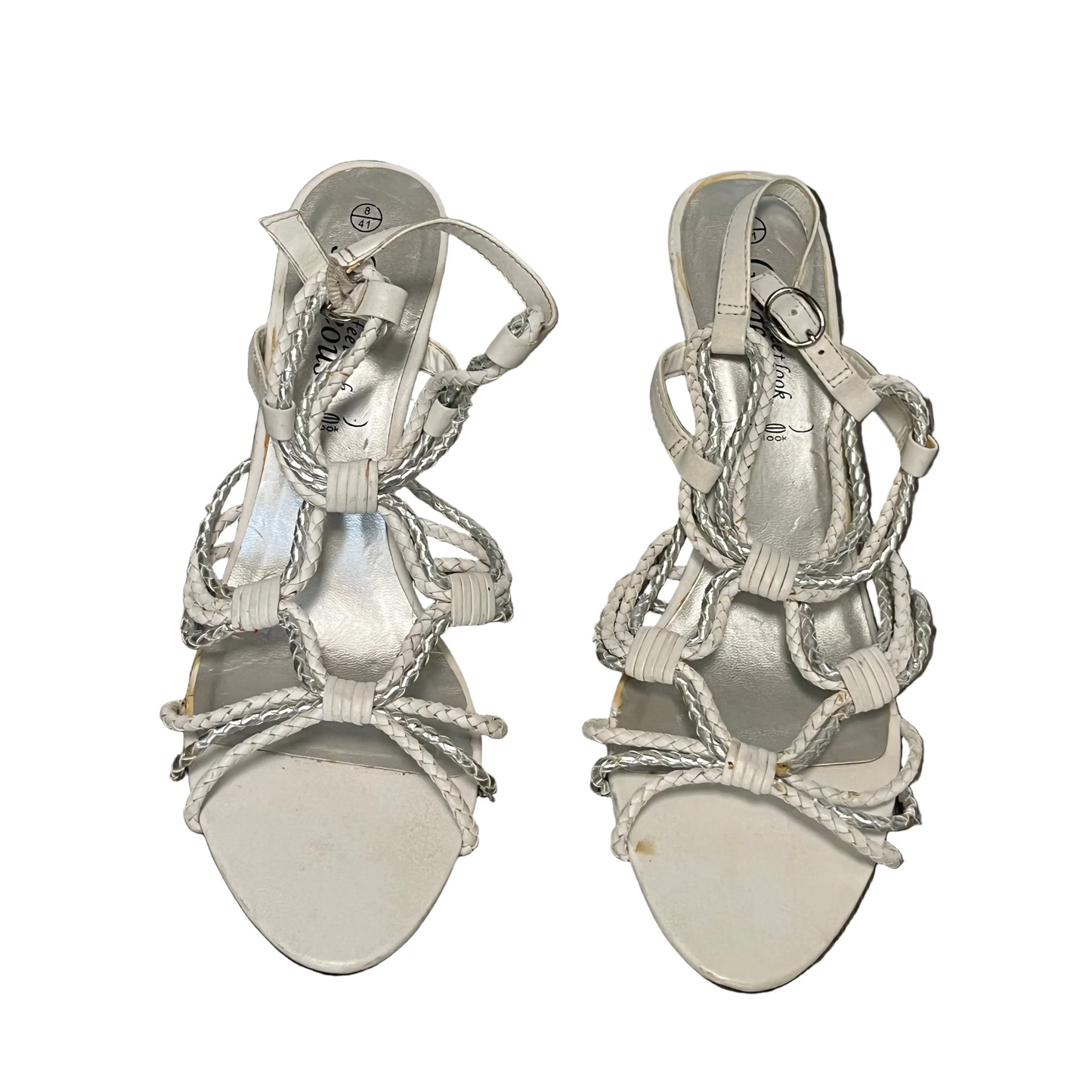 Pair of silver strappy sandals on a white background